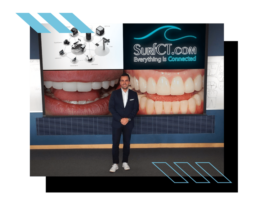 Man standing in front of a screen displaying teeth and SurfCT.com logo.