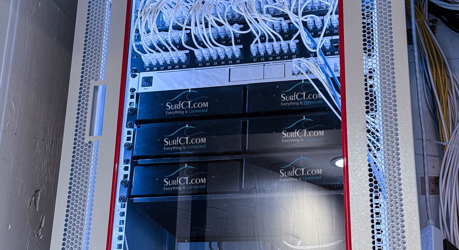 Server rack with black servers and white cables, likely a data center.