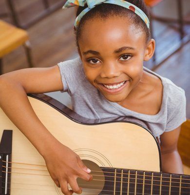 A Little Girl Playing Guitar — Carmel, IN — Carmel Music Academy