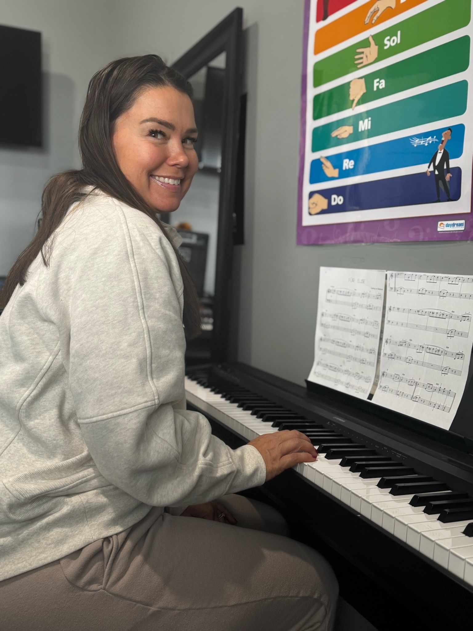 Woman Looking To A Keyboard Piano — Carmel, IN — Carmel Music Academy