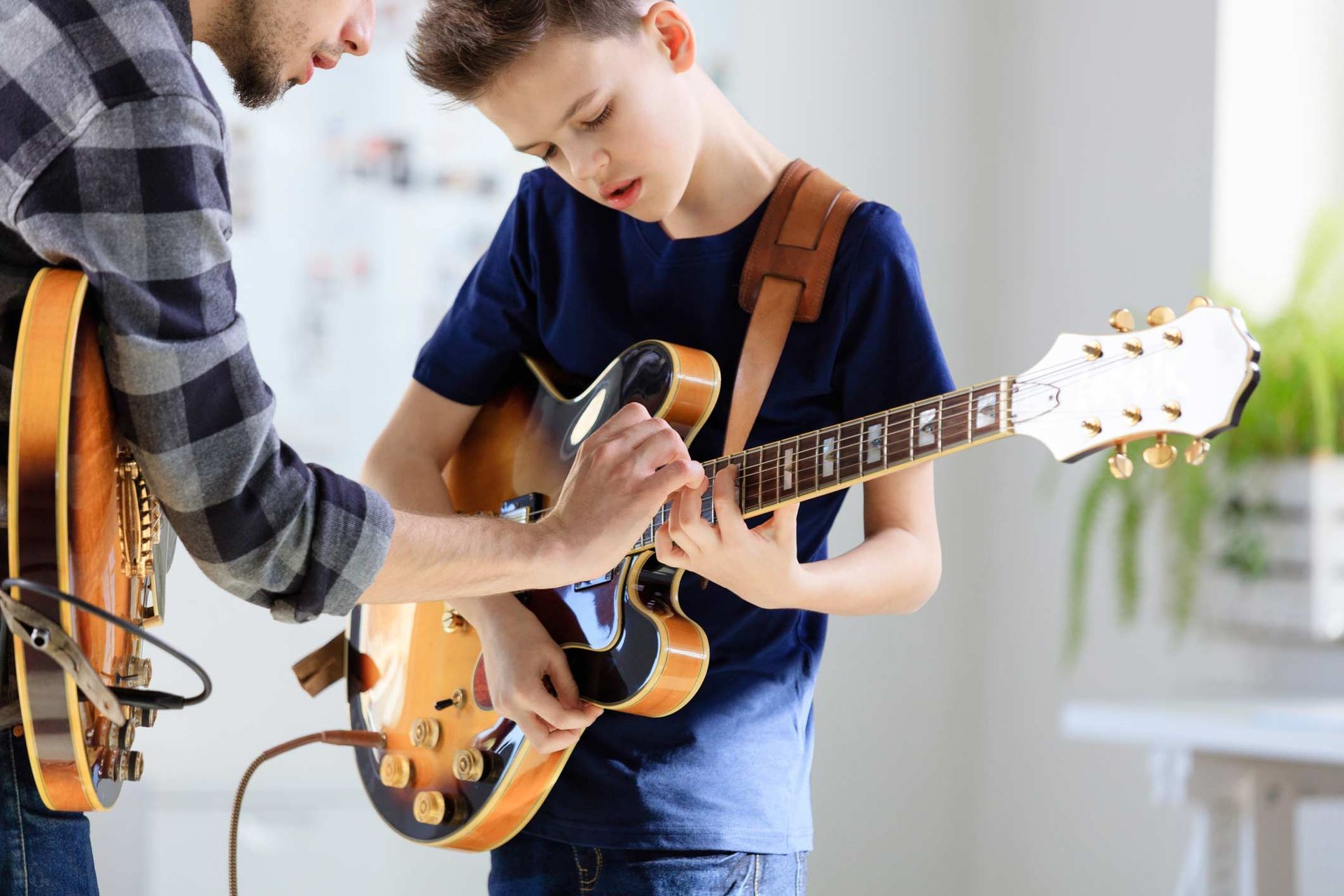 A Kid Learning To Play Guitar— Carmel, IN — Carmel Music Academy