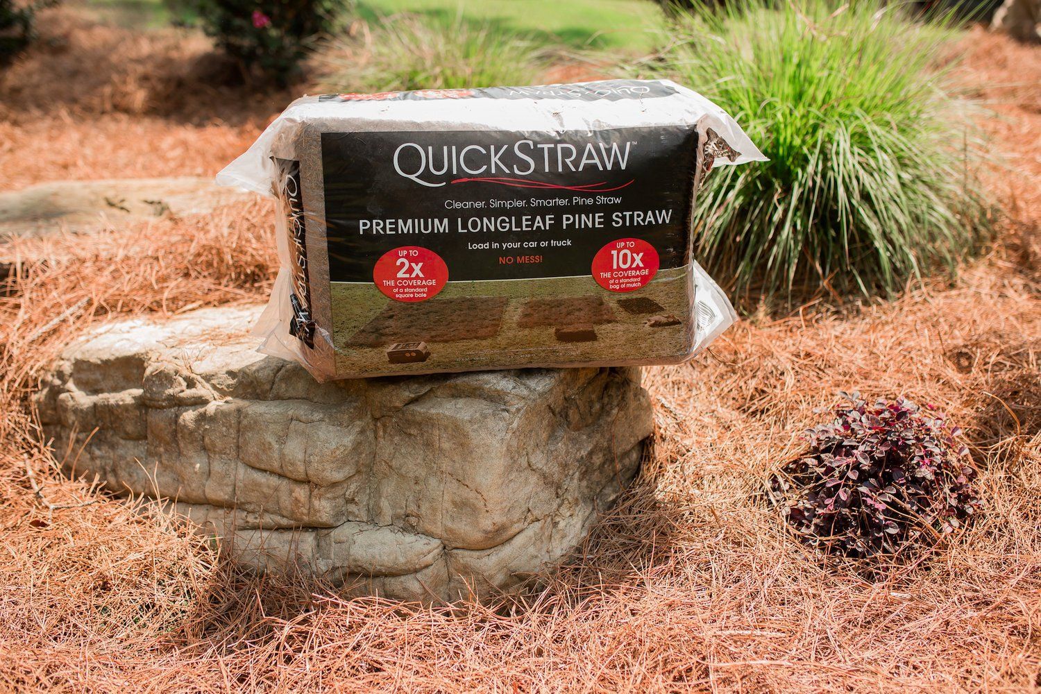 A bag of quickstraw is sitting on top of a rock.