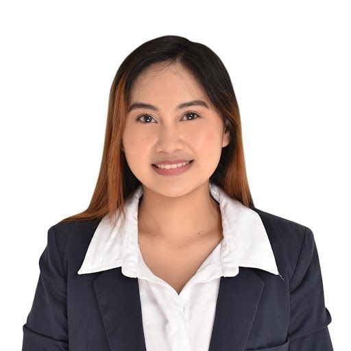 A woman in a suit and white shirt is smiling for the camera.