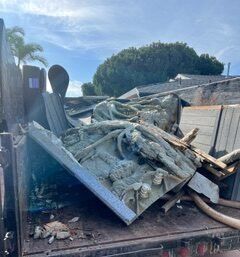 Truck bed filled with debris, including a detailed relief panel.