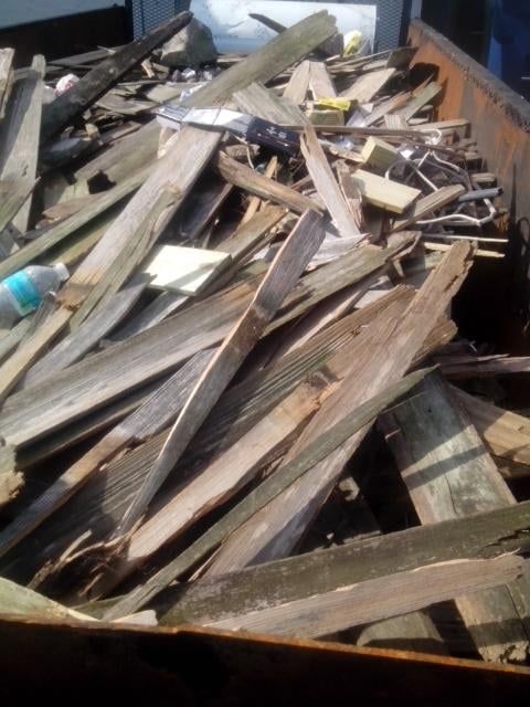 A pile of wood with a bottle of water in it