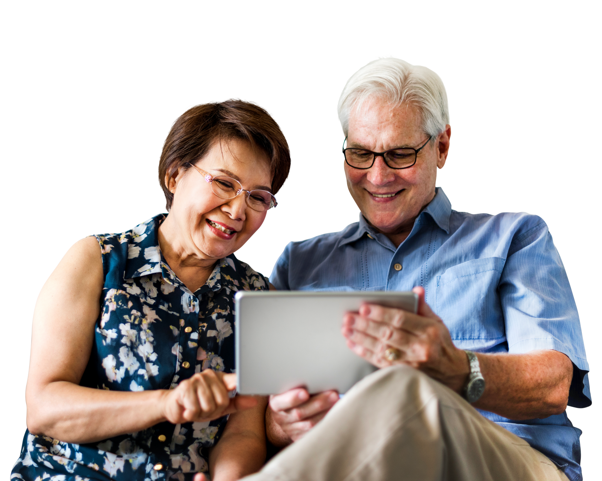 Couple smiling, looking at a tablet together, indoors. Woman points at the screen. Man wears glasses. Couple smiling, looking at a tablet together, indoors. Woman points at the screen. Man wears glasses.