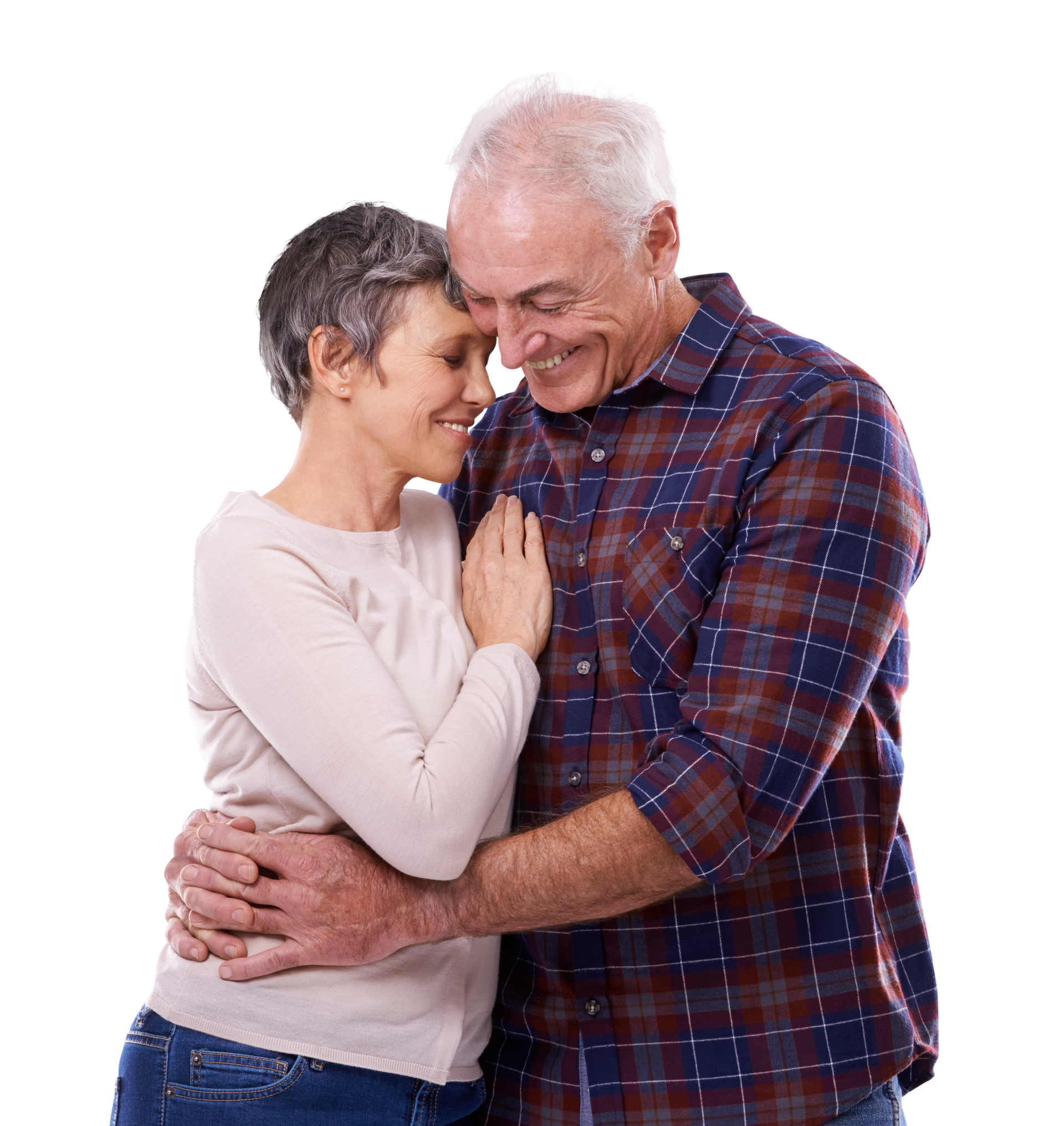 Older couple embracing and smiling; man in plaid shirt, woman in light sweater.