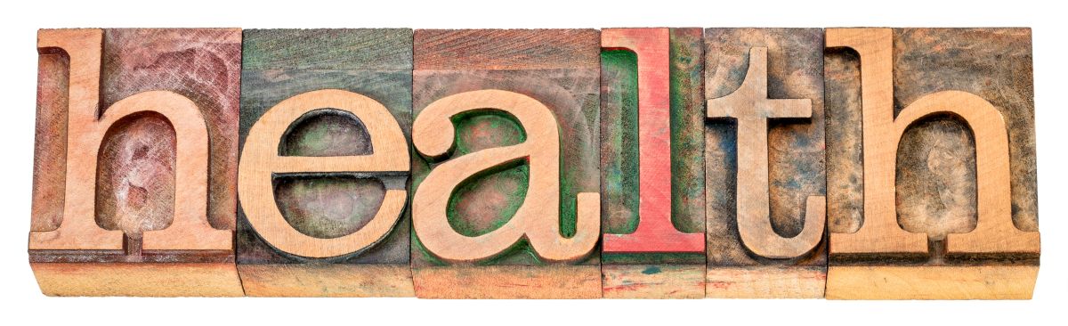 The word health is written in wooden letterpress type.