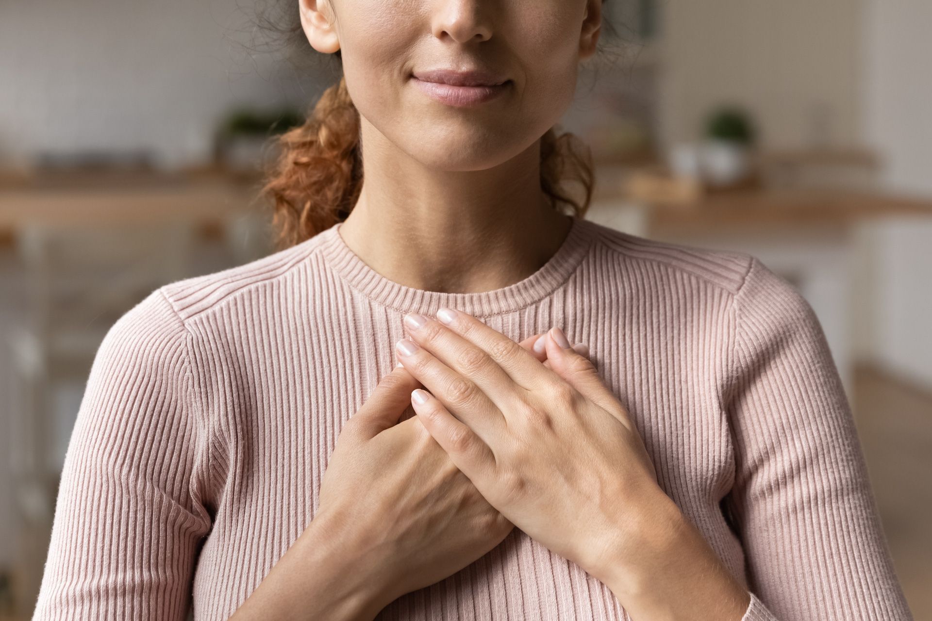 Woman with her hands on her chest