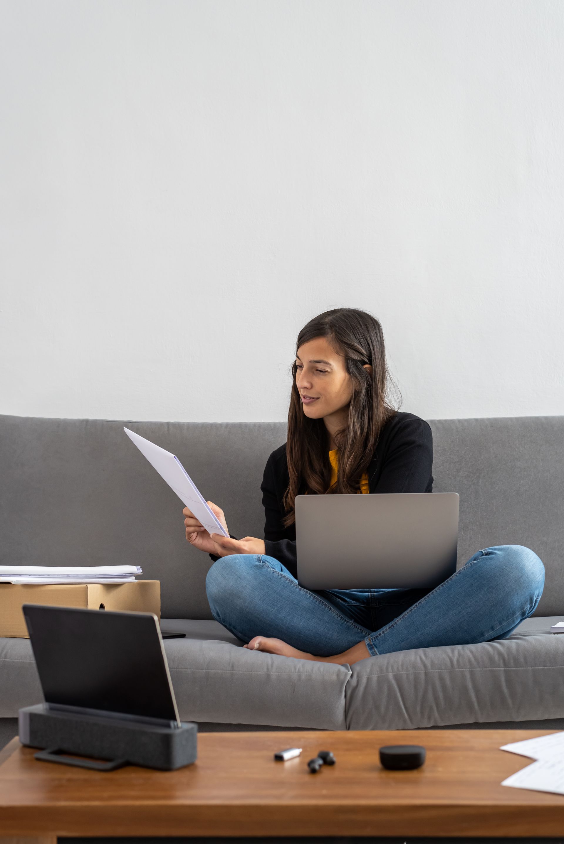 Older man with beard signing document, woman smiles beside him at a table.