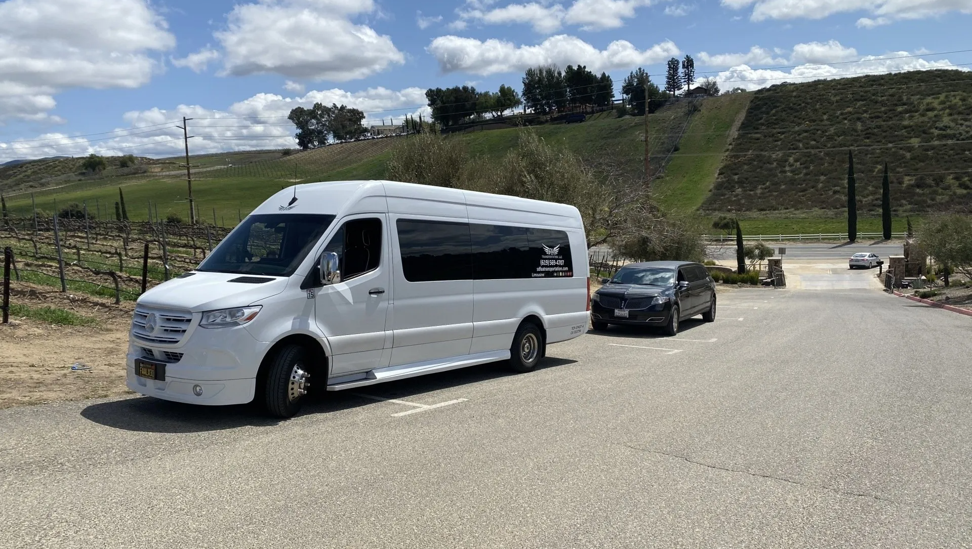 a white van is parked on the side of the road next to a black car .