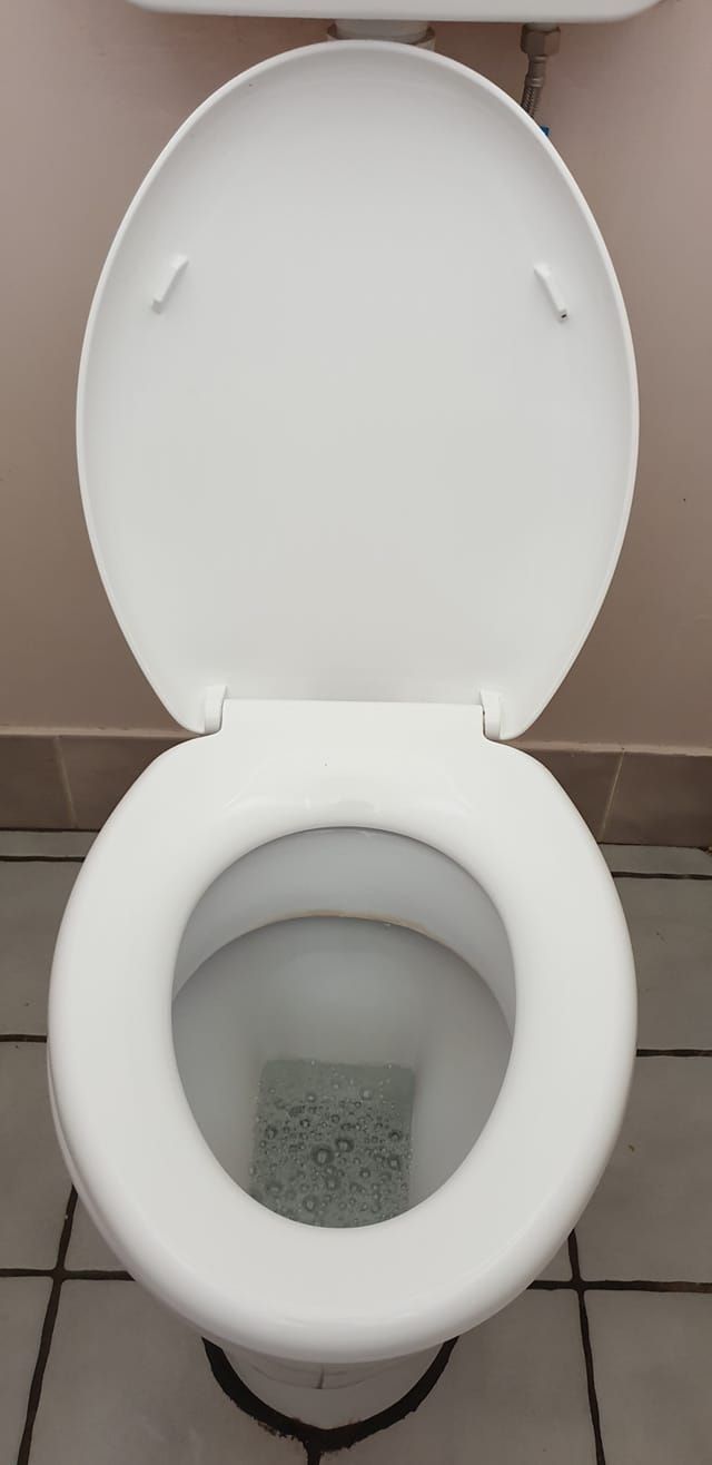 A White Toilet With the Lid Open in a Bathroom — Lease Clean Newcastle in Newcastle, NSW