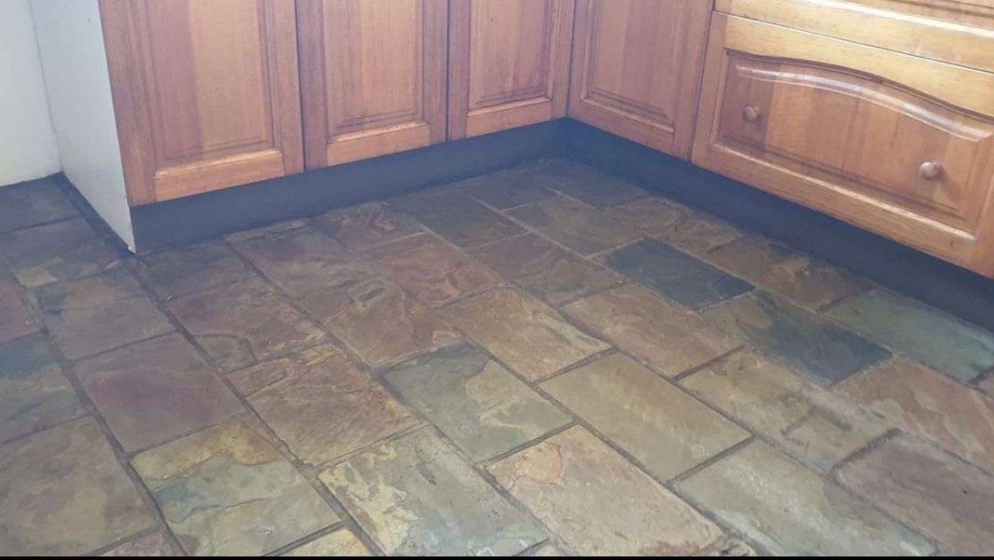 A Kitchen With a Tile Floor and Wooden Cabinets — Lease Clean Newcastle in Newcastle, NSW