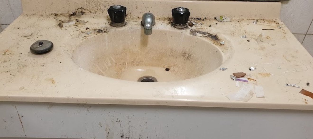A Bathroom Sink With a Dirty Counter Top and Faucet — Lease Clean Newcastle in Newcastle, NSW