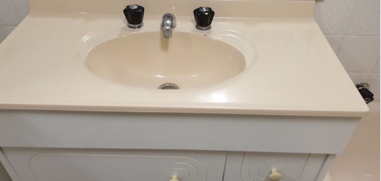 A Bathroom Sink With Black Handles and a White Counter Top — Lease Clean Newcastle in Newcastle, NSW