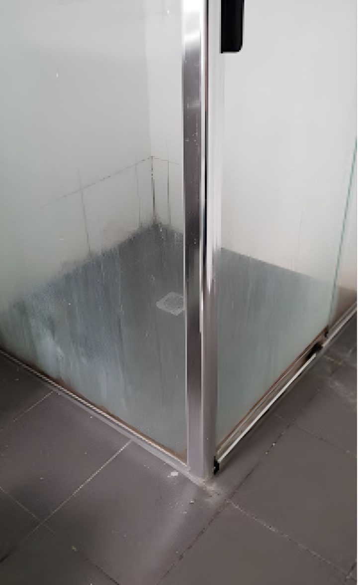 A Shower Stall With a Stainless Steel Frame and Dirty Glass — Lease Clean Newcastle in Newcastle, NSW