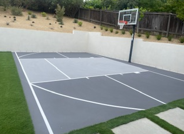 A basketball court with a fence in the background