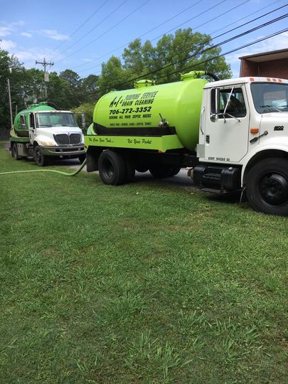 Sewage truck on city street in working process to clean up sewerage overflows in GA