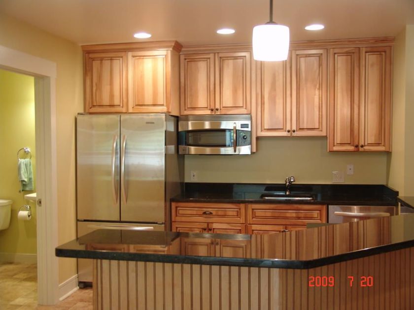 A kitchen with stainless steel appliances and wooden cabinets taken in 2009