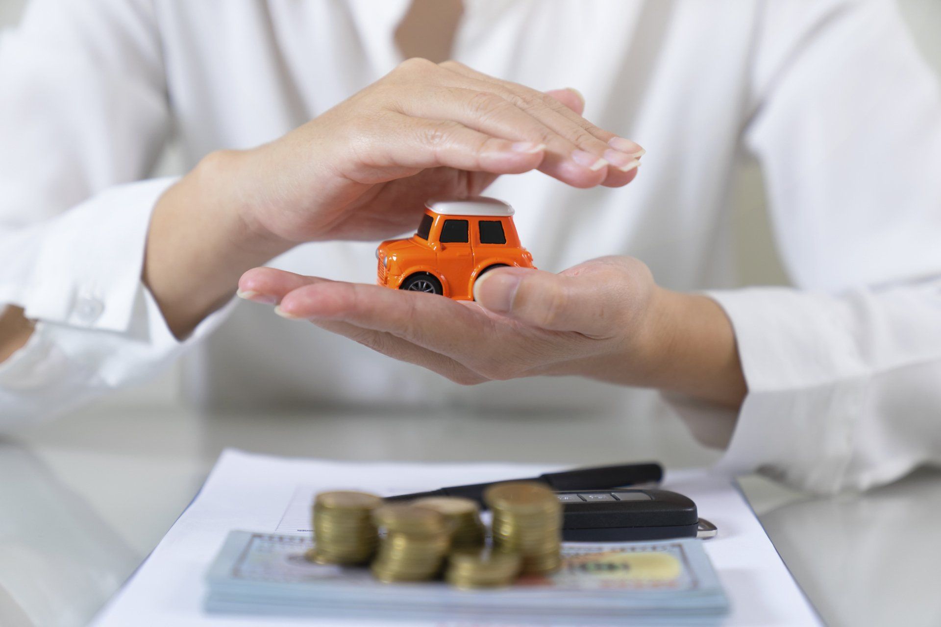 Hands Covering A Toy House — Flagstaff, AZ — Evans Insurance Inc. Hands Covering A Toy House — Flagstaff, AZ — Evans Insurance Inc.