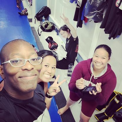 A group of people posing for a picture in a locker room