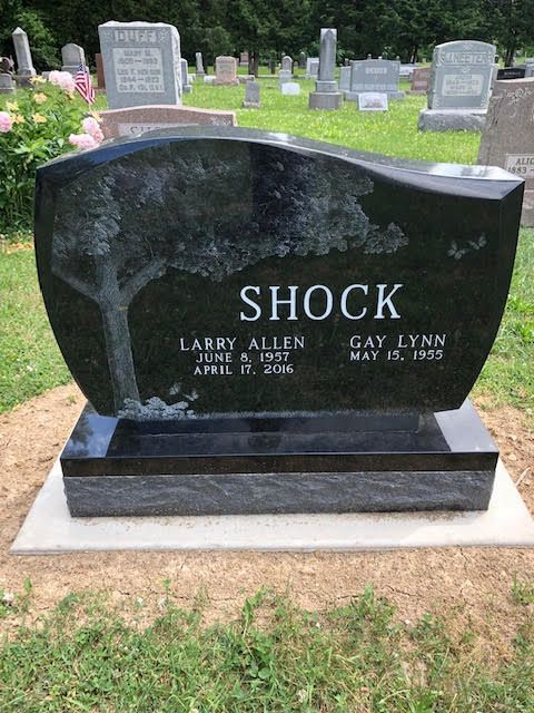 A black gravestone with the name shock on it