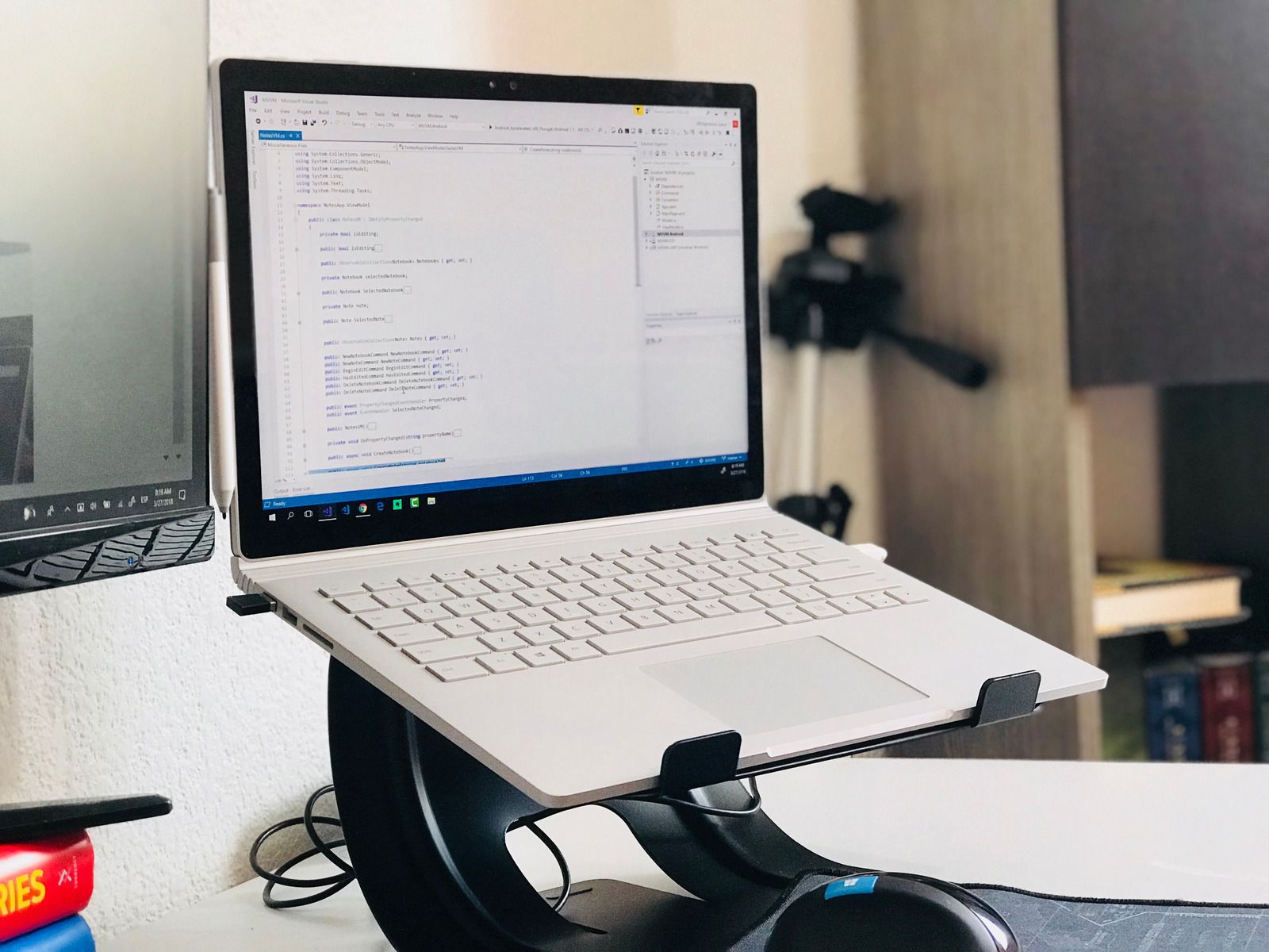 A laptop is sitting on top of a laptop stand.