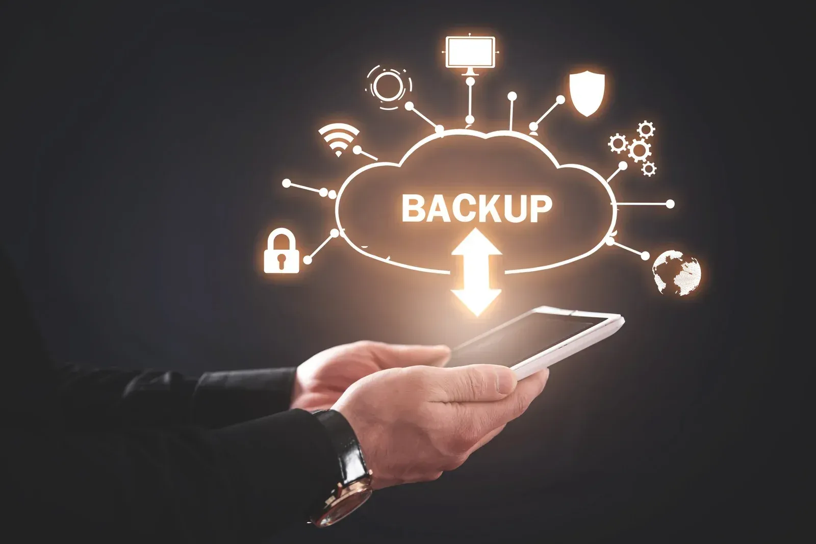 A person is holding a tablet with a backup icon on it.