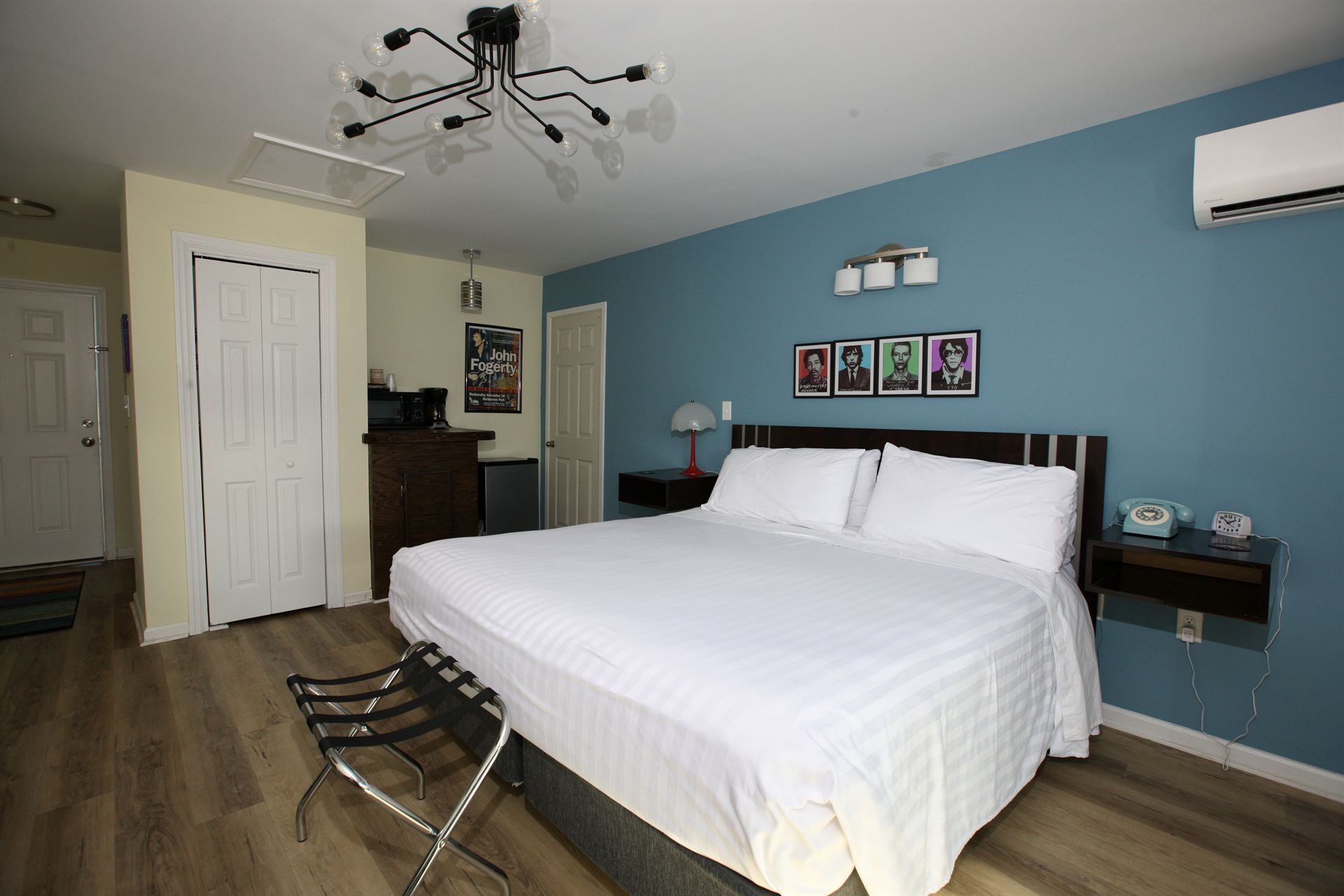 A bedroom with a king size bed and blue walls.