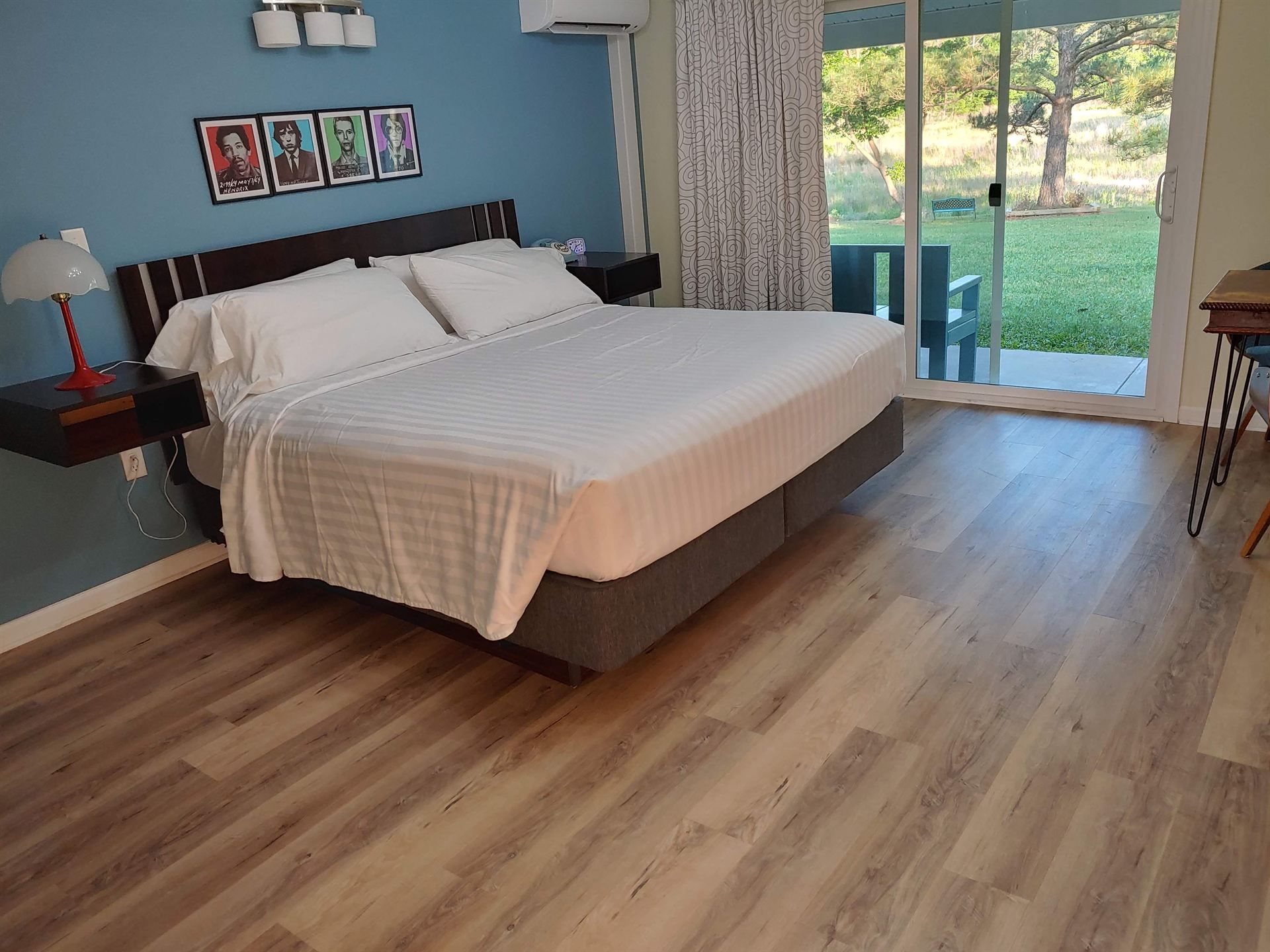 A hotel room with a large bed and a sliding glass door