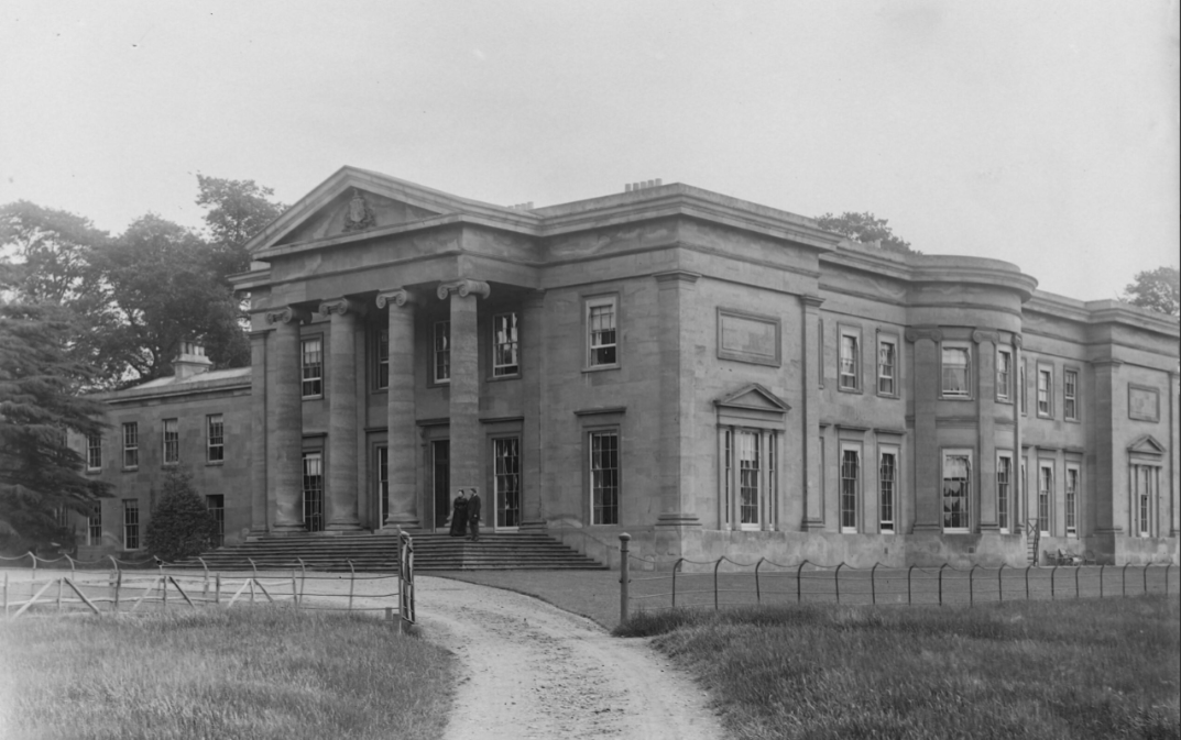 A black and white photo of a large building with columns.