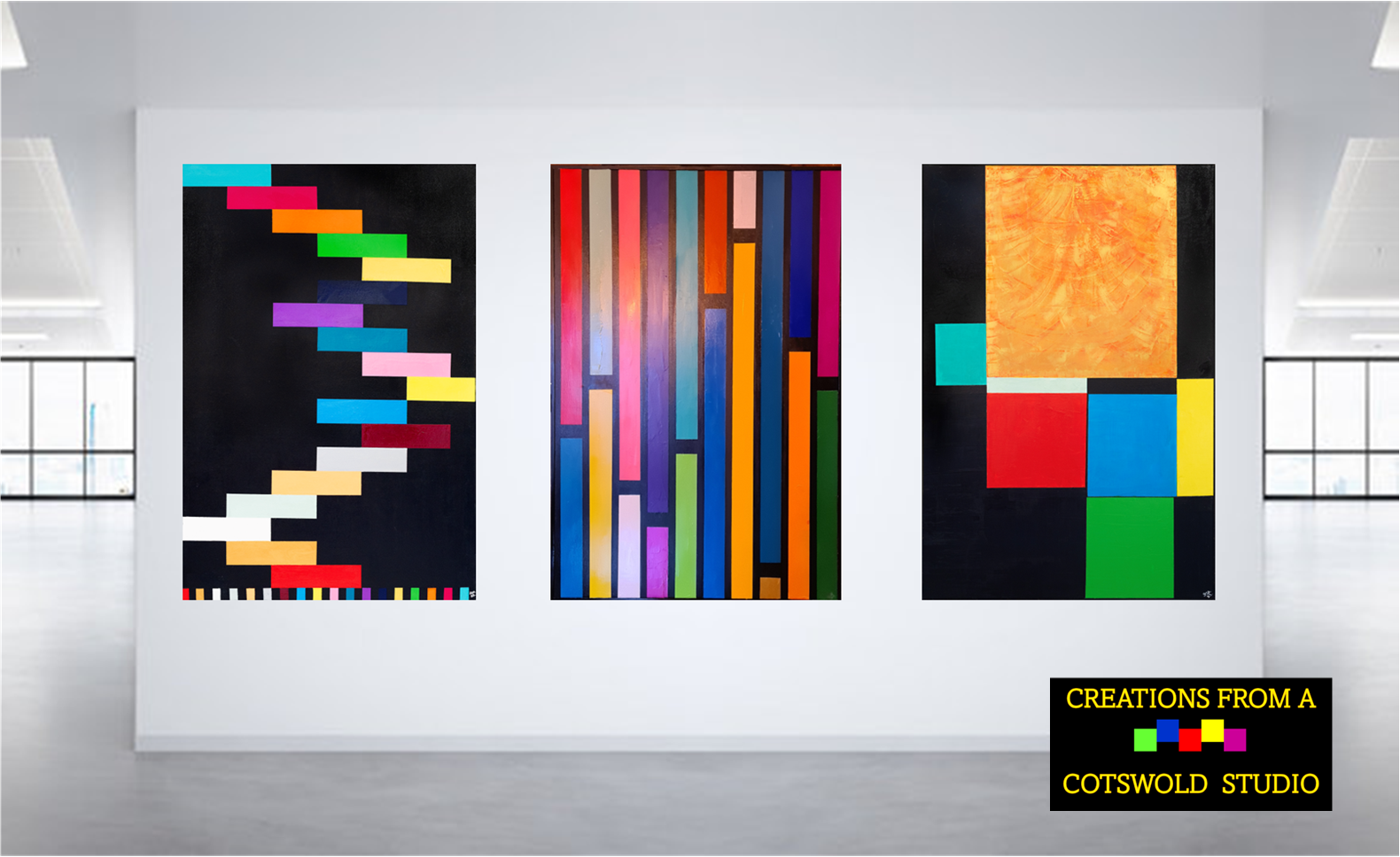 Three colorful paintings are hanging on a white wall.
