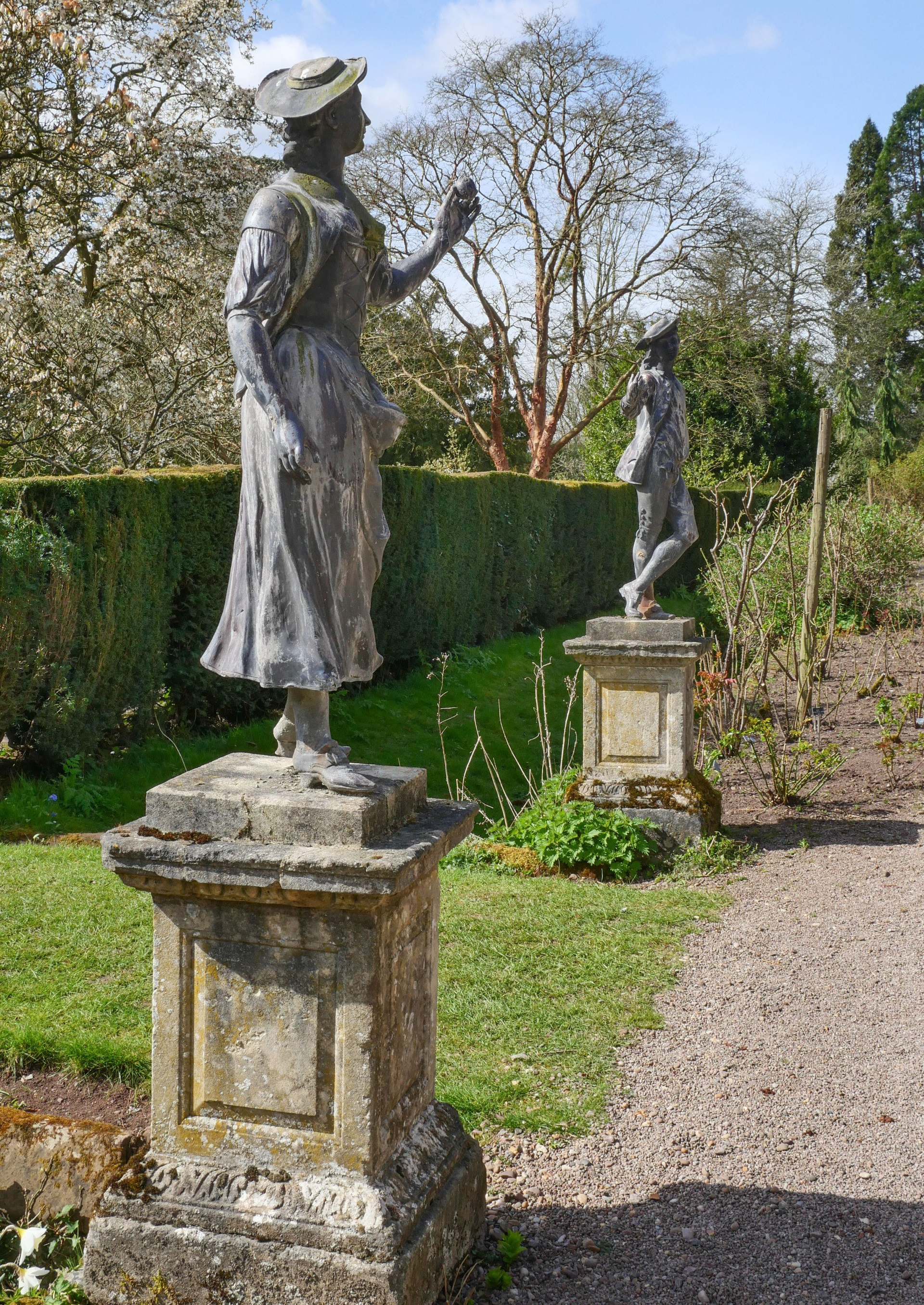 Two statues on pedestals in Spetchley Parks South Border