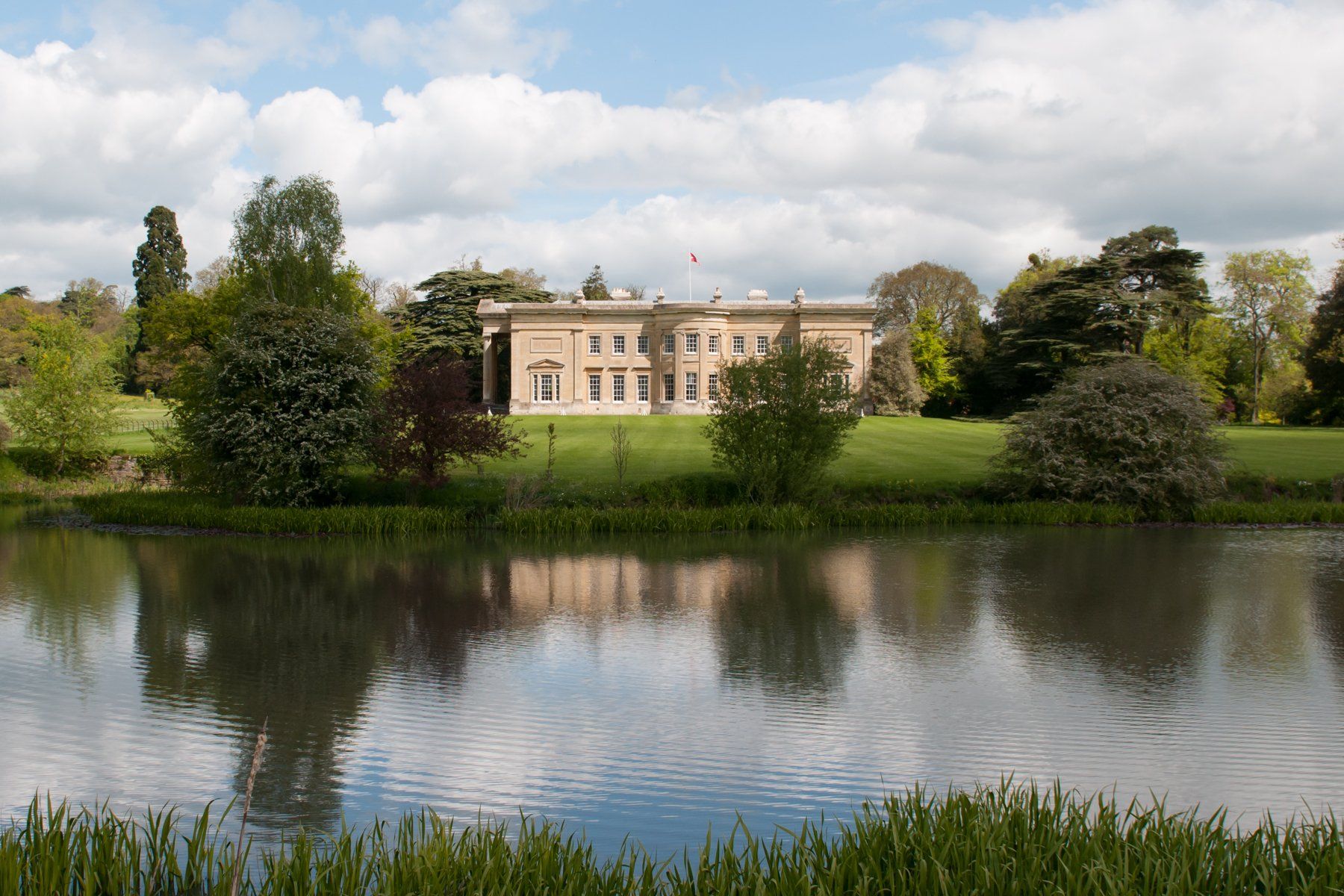 A large building is reflected in a body of water