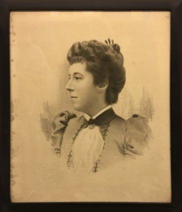 A black and white photo of a woman in a tuxedo.