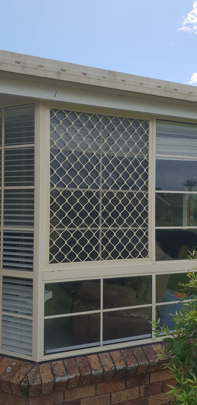 A White Window With a Mesh Screen on It is on the Side of a House — North Coast Screens & Repairs in East Ballina, NSW