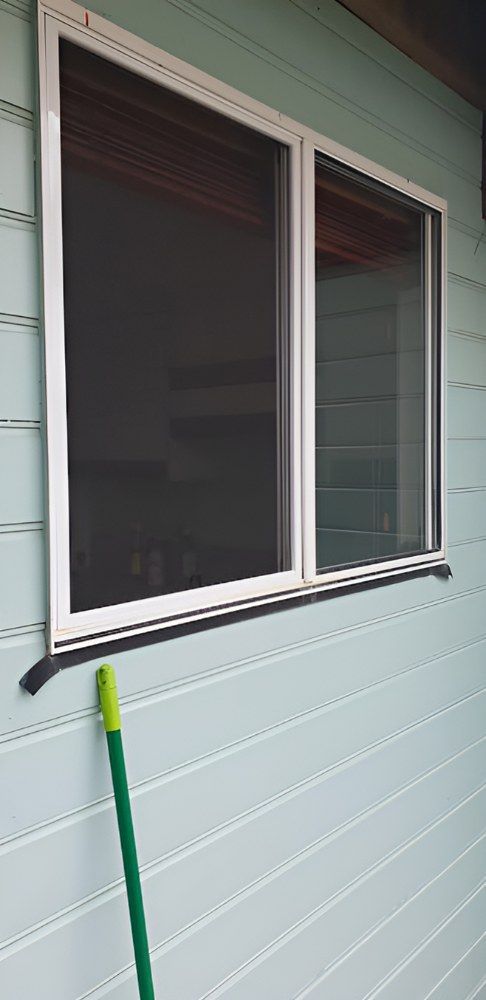 A Window With a Screen on It is on the Side of a House — North Coast Screens & Repairs in Byron Bay, NSW