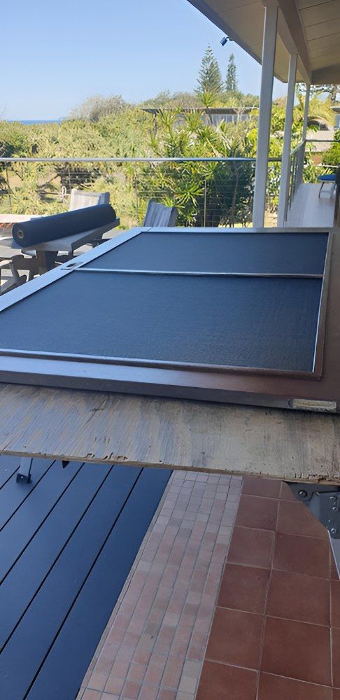A Screen is Sitting on Top of a Wooden Table — North Coast Screens & Repairs in Goonellabah, NSW