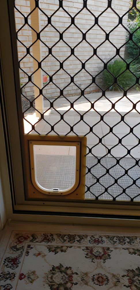 A Screened Door With a Cat Door — North Coast Screens & Repairs in Ballina, NSW