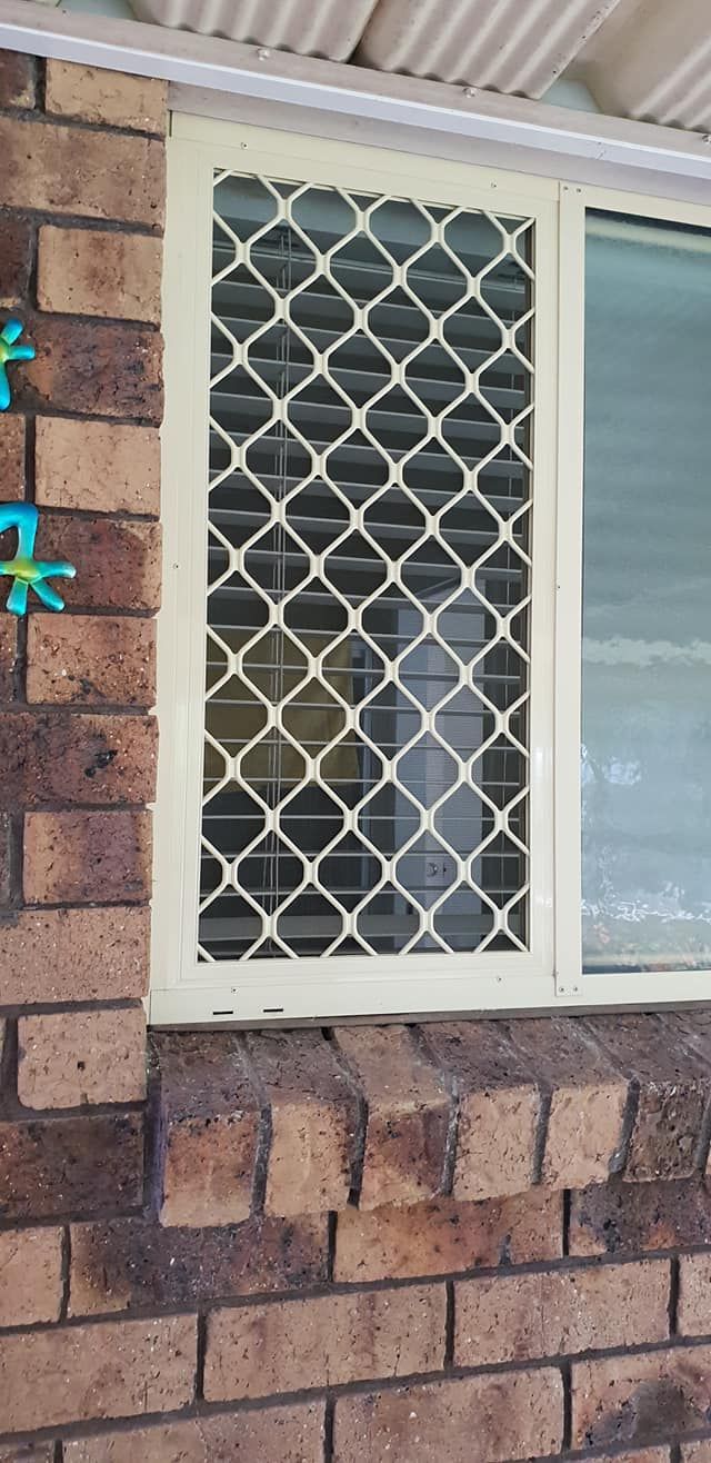 A Window With a Mesh Screen on a Brick Wall — North Coast Screens & Repairs in Ballina, NSW