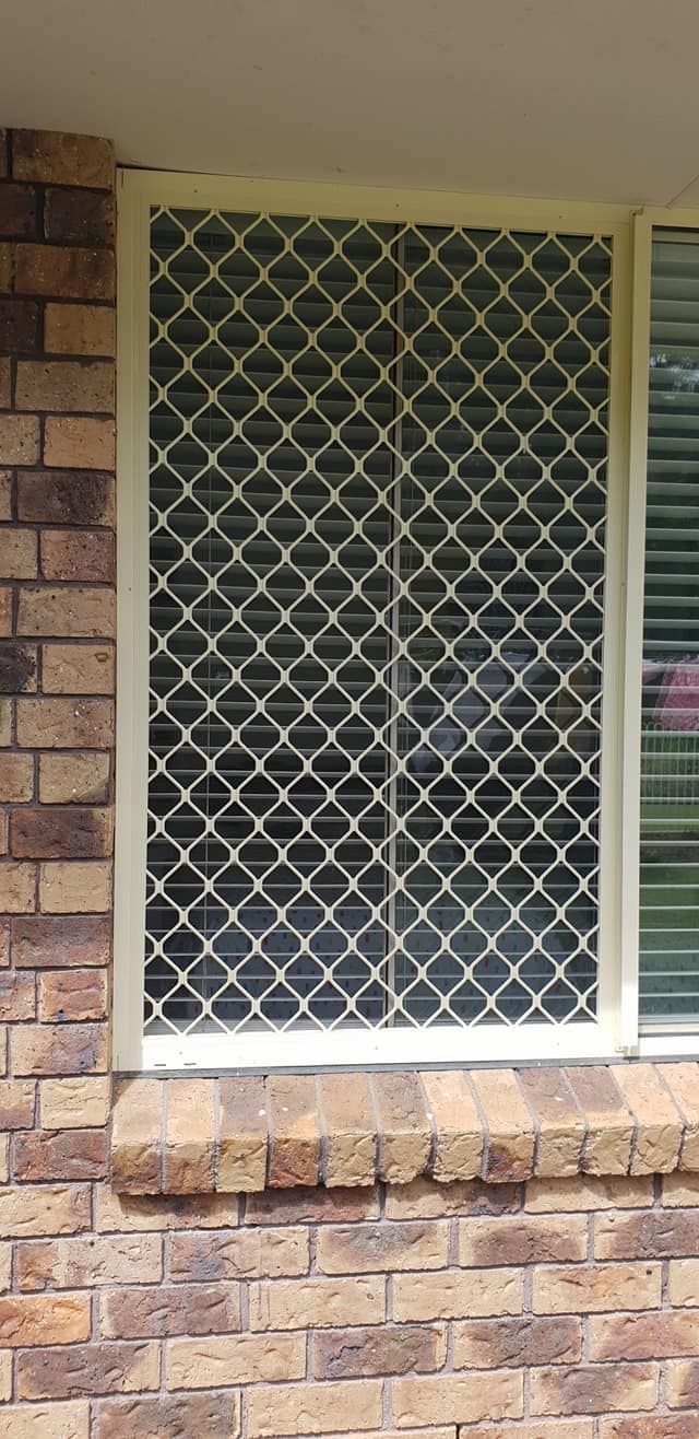A Window With a Screen on It is on a Brick Wall — North Coast Screens & Repairs in Byron Bay, NSW