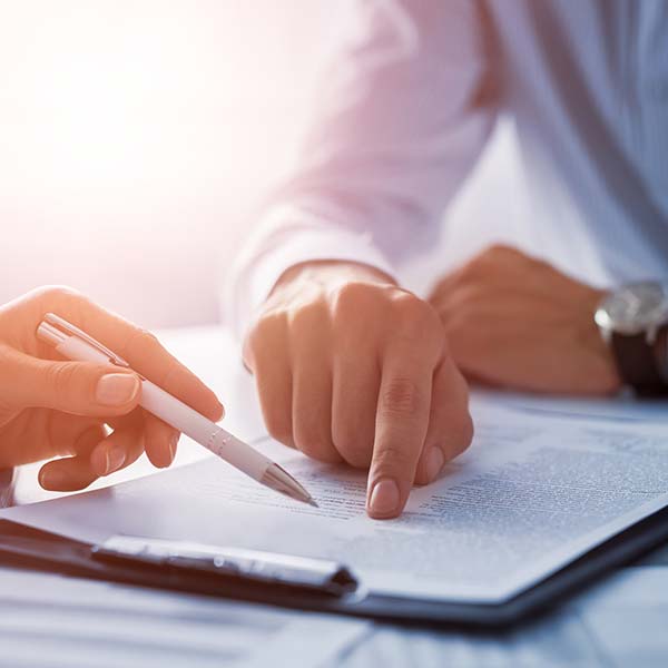 Title Loans — Documents at Desk and Signing Contract in Humble, TX