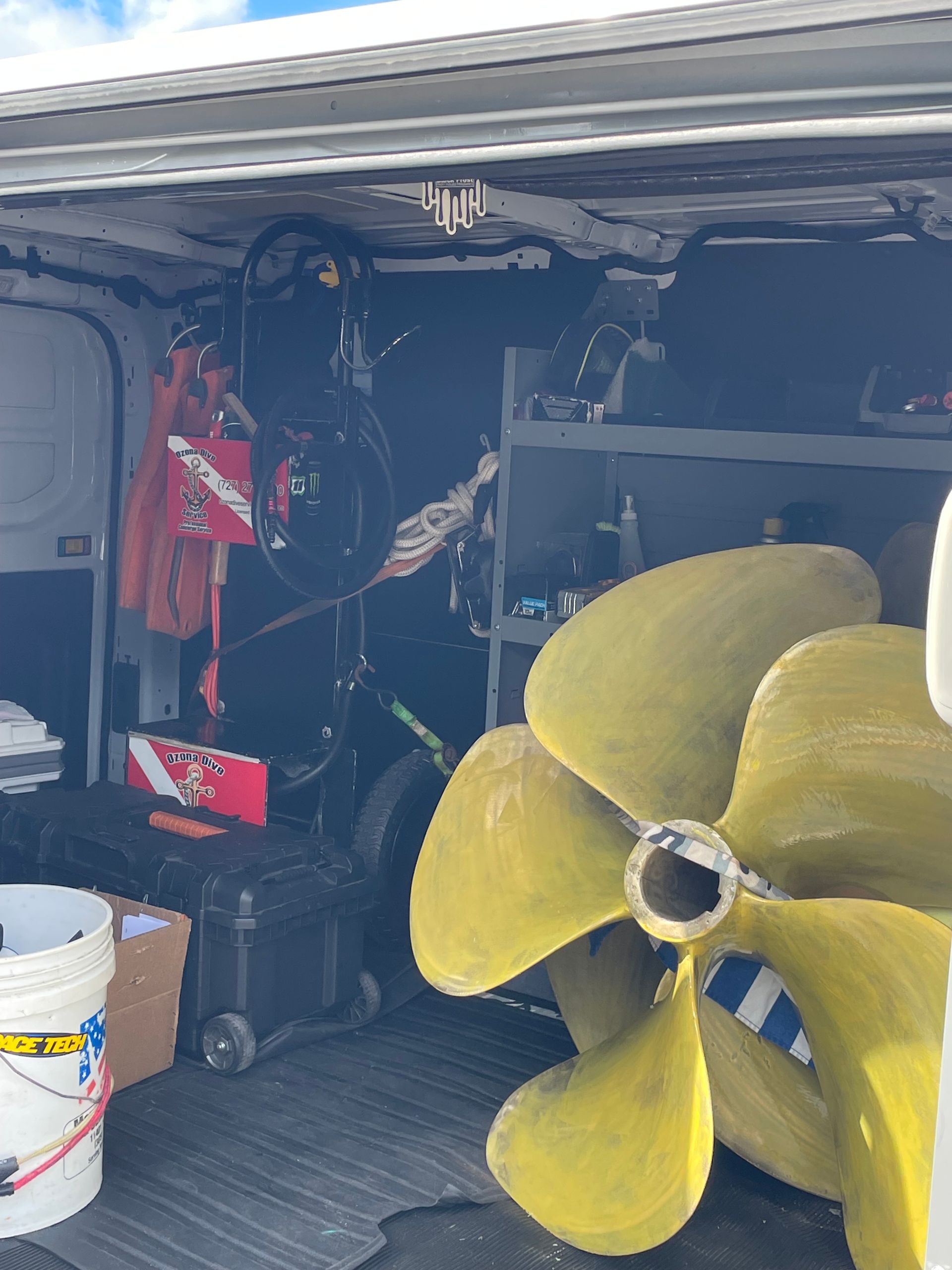 A Large Yellow Propeller is Sitting in the Back of a Van — Palm Harbor, FL — Ozona Dive Service
