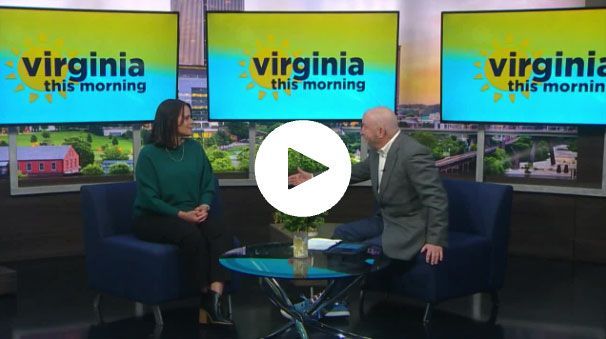 Julie sitting in front of a virginia this morning television set 