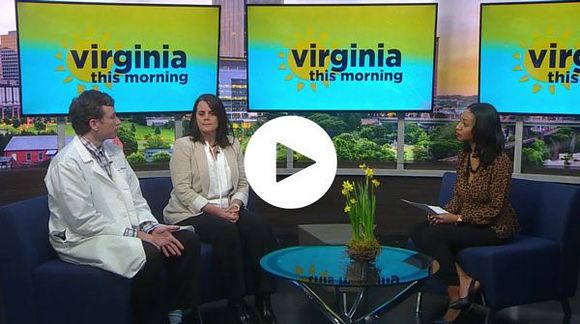 Julie sitting in front of a virginia this morning television set 