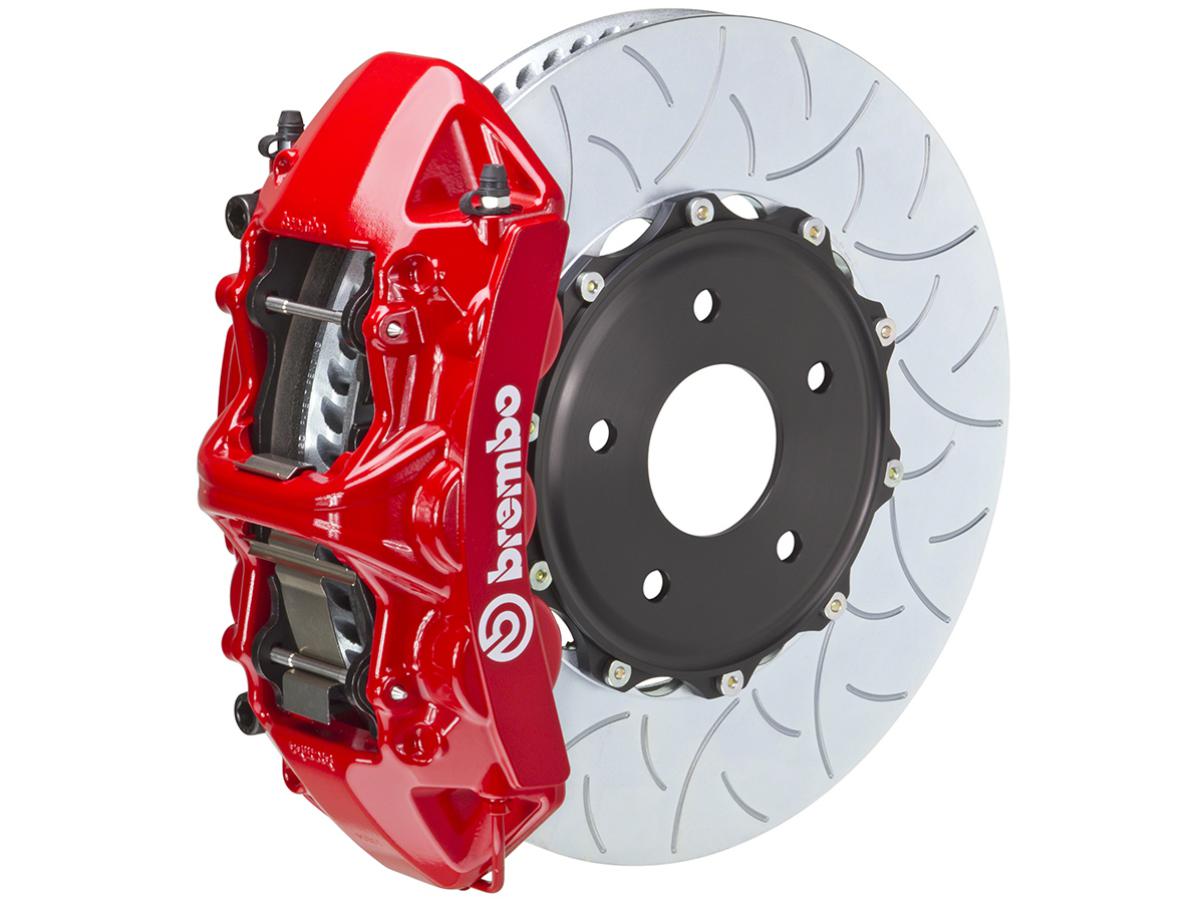 A red brembo brake caliper and rotor on a white background