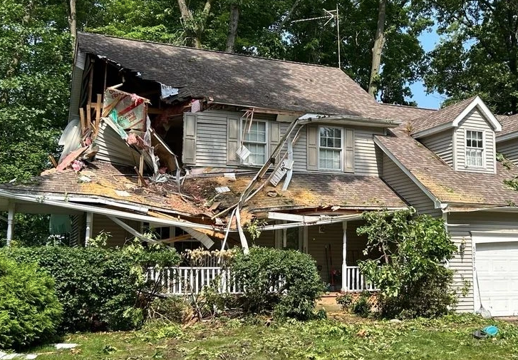 A red white and blue flag with a white star is in a field of blue flowers