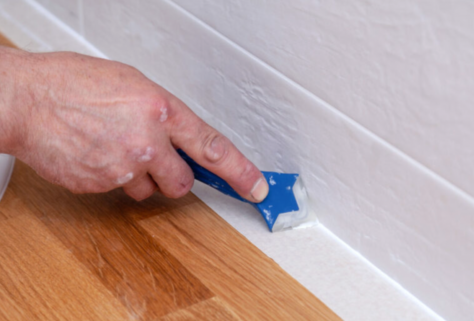 A kitchen with granite counter tops , wooden cabinets , a stove and a microwave.