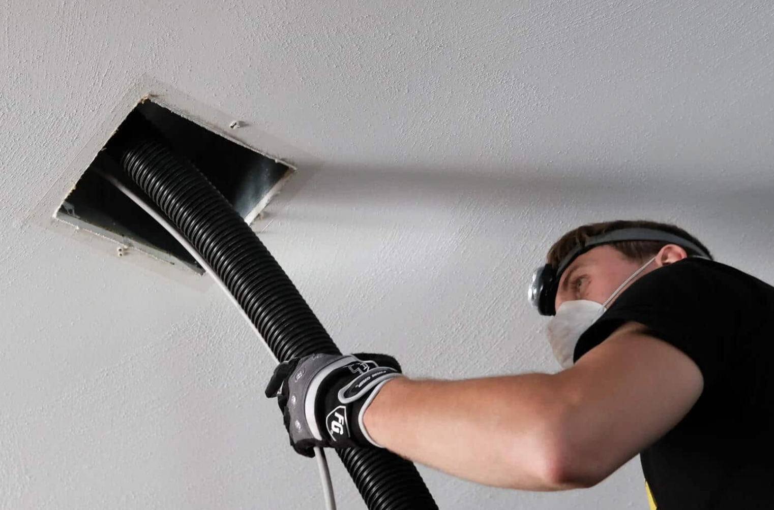 A close up of a dirty air duct with a hole in the middle.