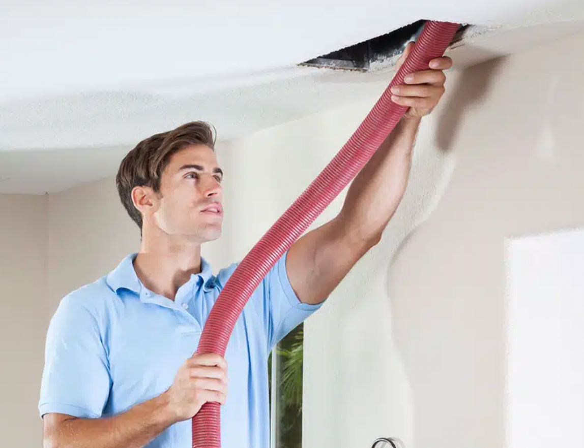 A close up of a dirty air duct with a hole in the middle.